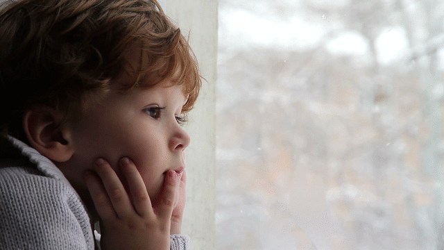 child watching snow fall